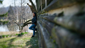 model leaning against wall
